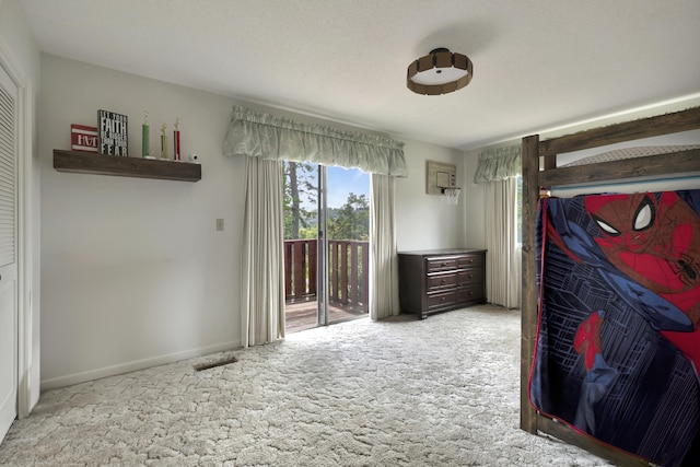 bedroom with access to exterior and light carpet