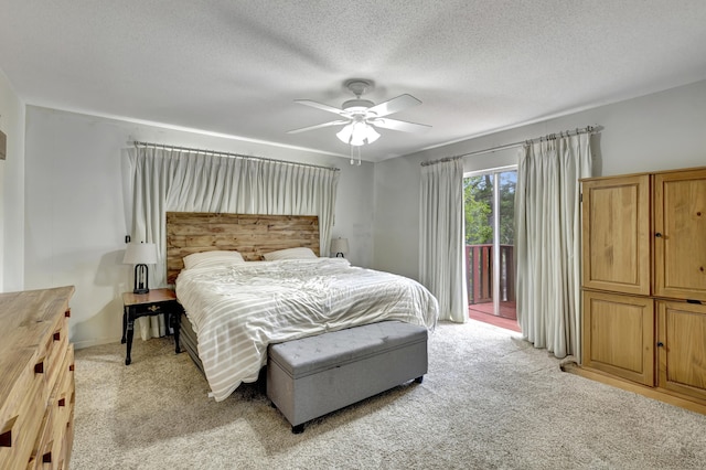 bedroom featuring access to exterior, light carpet, a textured ceiling, and ceiling fan