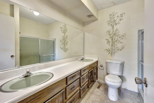 bathroom with an enclosed shower, vanity, and toilet