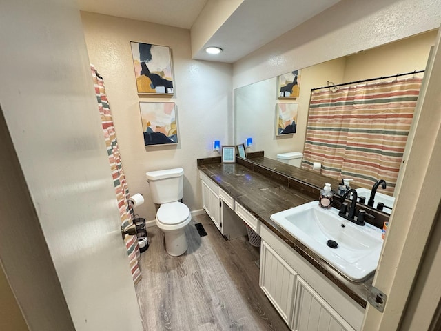 bathroom featuring hardwood / wood-style floors, vanity, and toilet