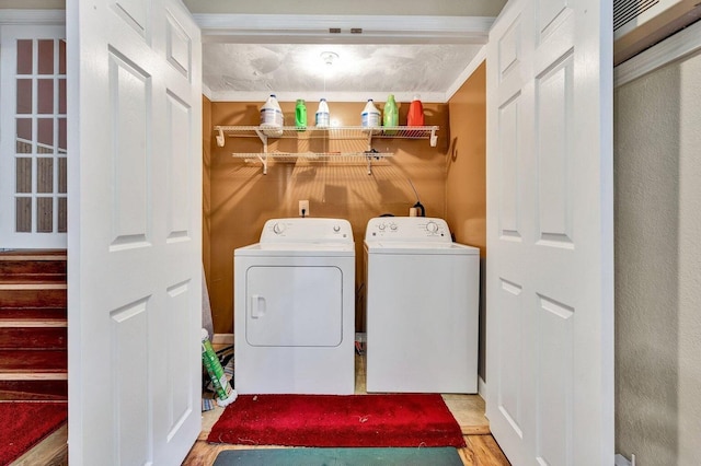 laundry room featuring washer and clothes dryer and hardwood / wood-style flooring