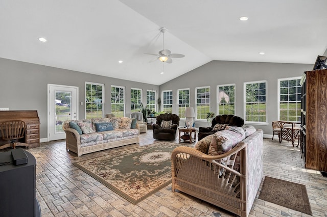 living room featuring lofted ceiling, ceiling fan, and plenty of natural light