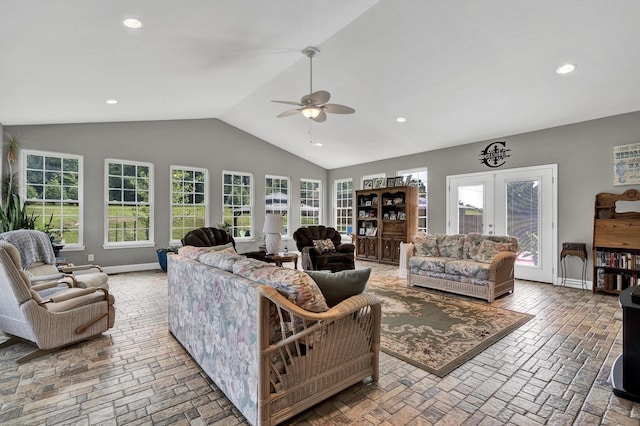 living room with vaulted ceiling, ceiling fan, and french doors