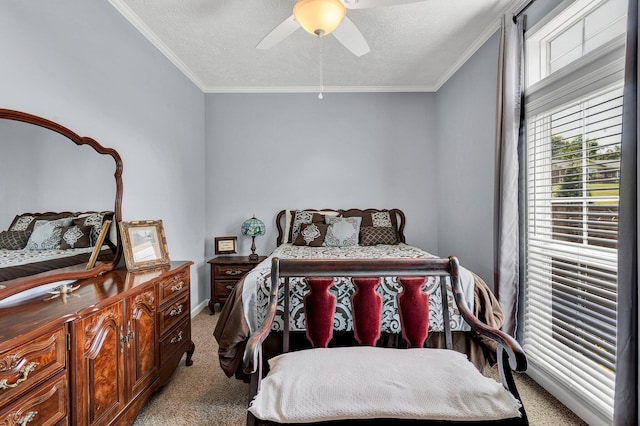 carpeted bedroom with a textured ceiling, ornamental molding, and ceiling fan