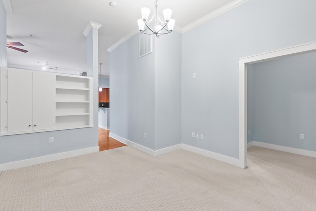 interior space with ceiling fan with notable chandelier and ornamental molding