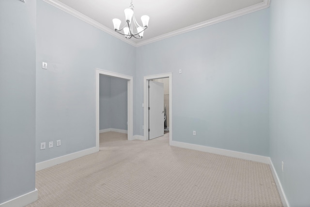 unfurnished room featuring light carpet, an inviting chandelier, and crown molding