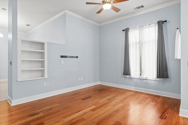 unfurnished room with ornamental molding, ceiling fan, hardwood / wood-style flooring, and built in features