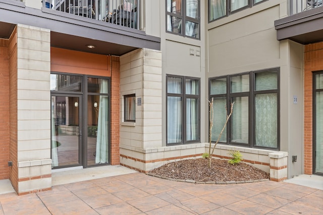 doorway to property featuring a balcony and a patio area