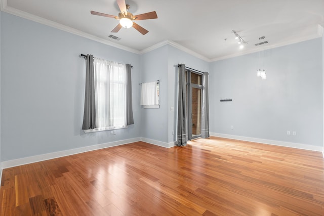 spare room with ceiling fan, ornamental molding, wood-type flooring, and rail lighting