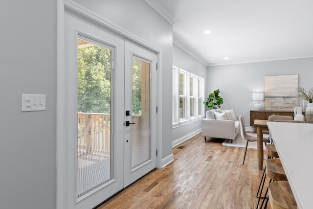 doorway with french doors, light hardwood / wood-style flooring, and crown molding