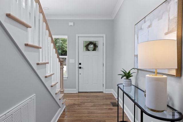 entryway with crown molding and dark wood-type flooring