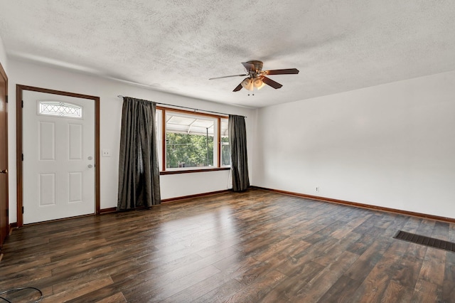 interior space with ceiling fan, dark wood-type flooring, and a textured ceiling