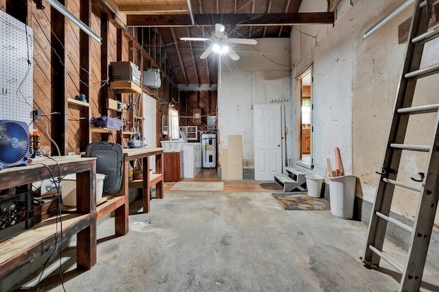 misc room with a workshop area, washer / dryer, electric water heater, concrete flooring, and ceiling fan