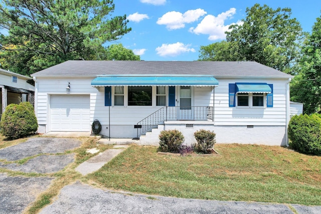 single story home featuring a front yard, a porch, and a garage