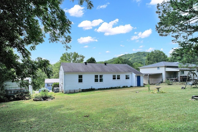 rear view of property with a yard