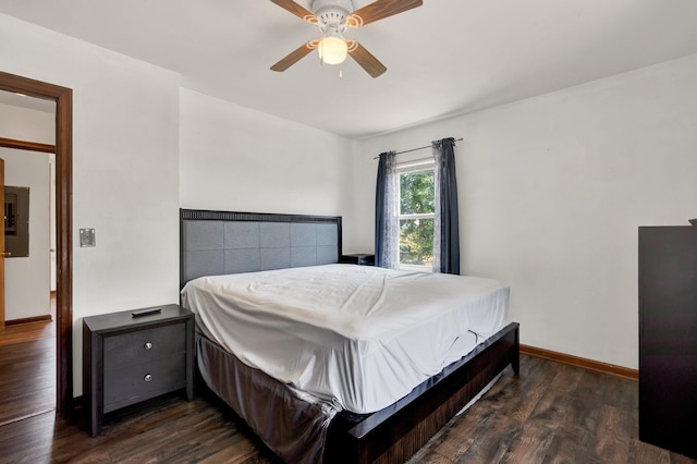 bedroom with dark hardwood / wood-style flooring and ceiling fan