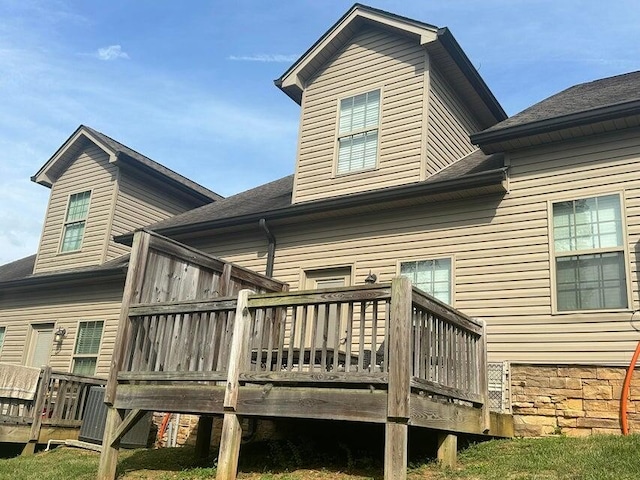 rear view of property with a wooden deck and central air condition unit