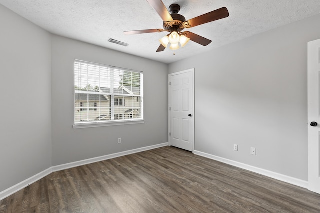 unfurnished room featuring a textured ceiling, dark hardwood / wood-style flooring, and ceiling fan