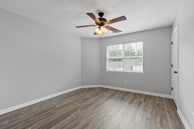 empty room with ceiling fan, a textured ceiling, and dark hardwood / wood-style floors