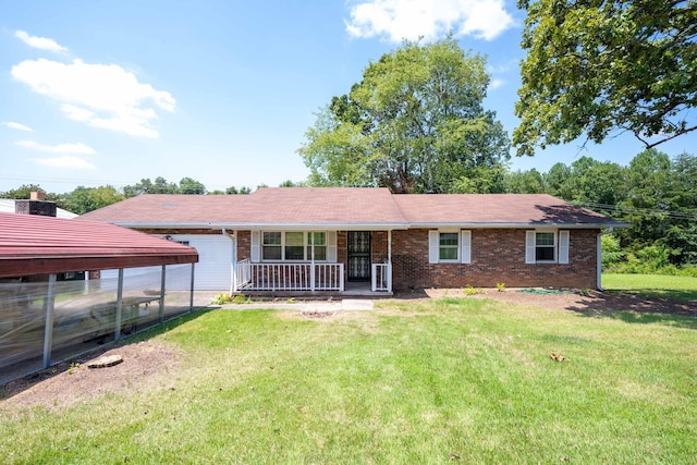 view of front of house with a front yard, covered porch, and a carport