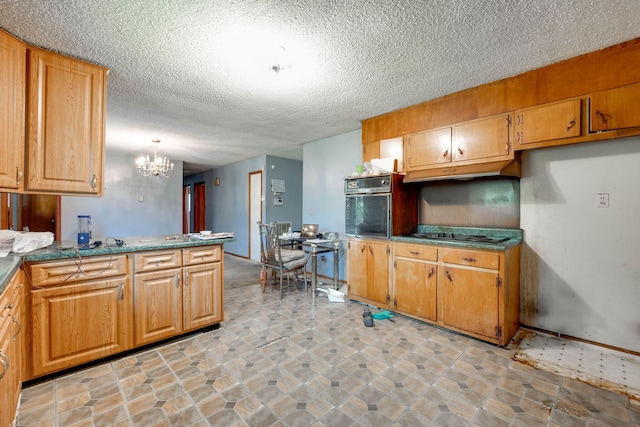 kitchen with a textured ceiling, black appliances, a chandelier, and decorative light fixtures