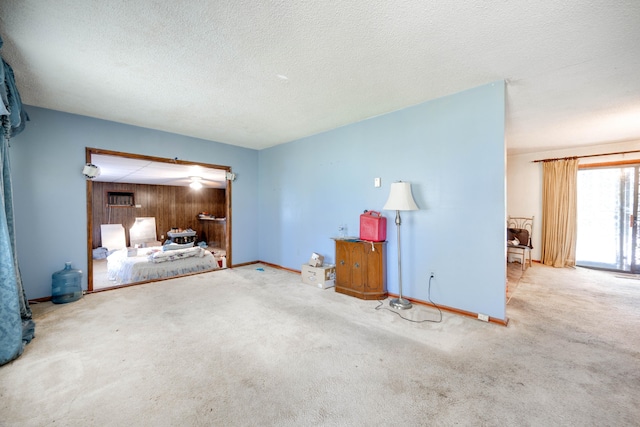 interior space featuring a textured ceiling and carpet flooring