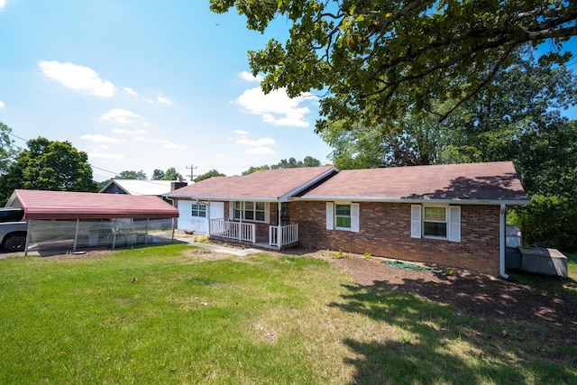 4803 Cordelia Ln, Chattanooga, TN 37416 - back of property with brick siding, a lawn, covered porch, and a carport