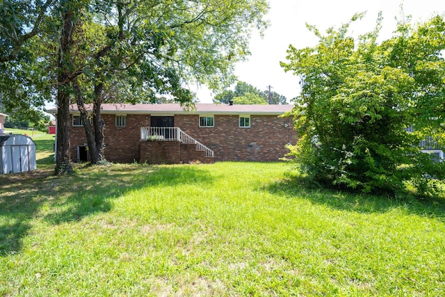 4803 Cordelia Ln, Chattanooga, TN 37416 - back of house with a shed, a lawn, and brick siding