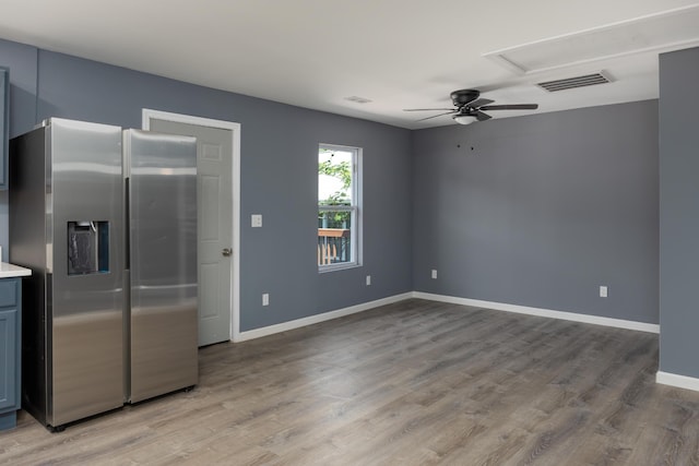 kitchen with light hardwood / wood-style flooring, ceiling fan, and stainless steel fridge