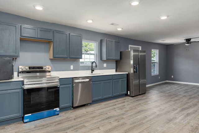 kitchen with sink, ceiling fan, stainless steel appliances, and a wealth of natural light