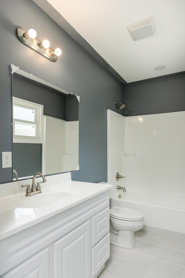 full bathroom featuring vanity, toilet, and  shower combination