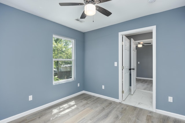 unfurnished bedroom featuring light wood-type flooring and ceiling fan