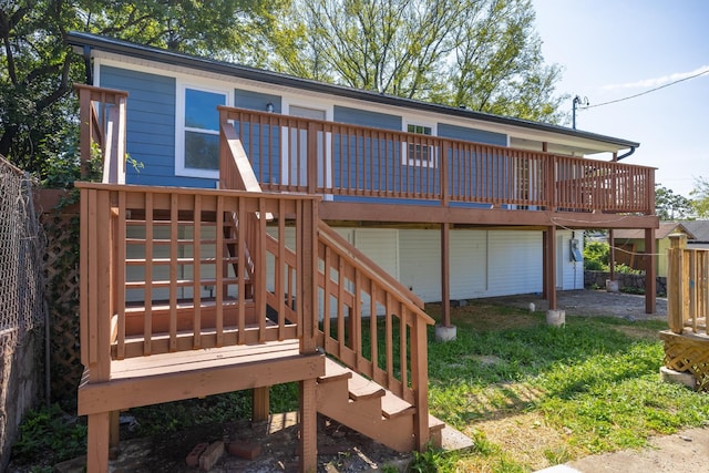 rear view of property featuring a deck