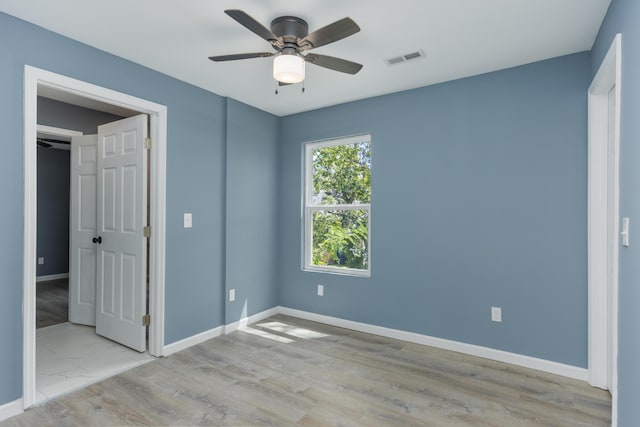 unfurnished bedroom with light wood-type flooring and ceiling fan