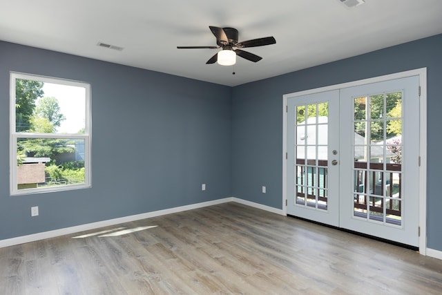 spare room featuring ceiling fan, french doors, and light hardwood / wood-style flooring