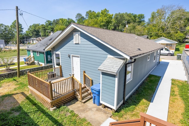 back of house featuring a wooden deck