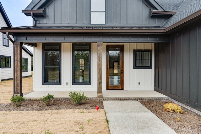 view of exterior entry with covered porch