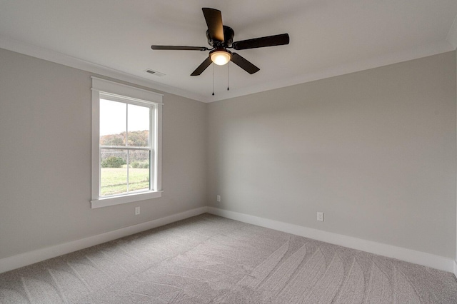 spare room featuring ceiling fan, carpet floors, and ornamental molding