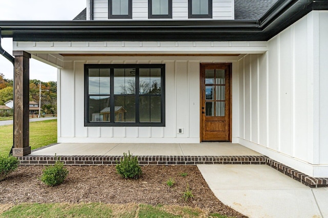 view of exterior entry featuring covered porch