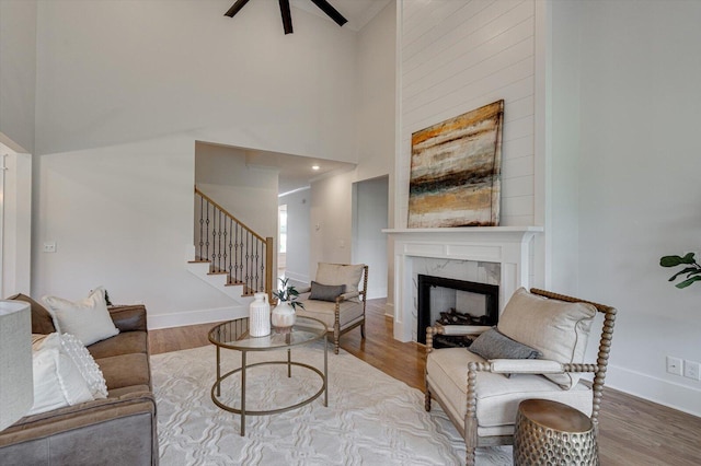 105 Arthur Ln, Cleveland, TN 37312 - living room with a premium fireplace, ceiling fan, stairway, wood finished floors, and a towering ceiling