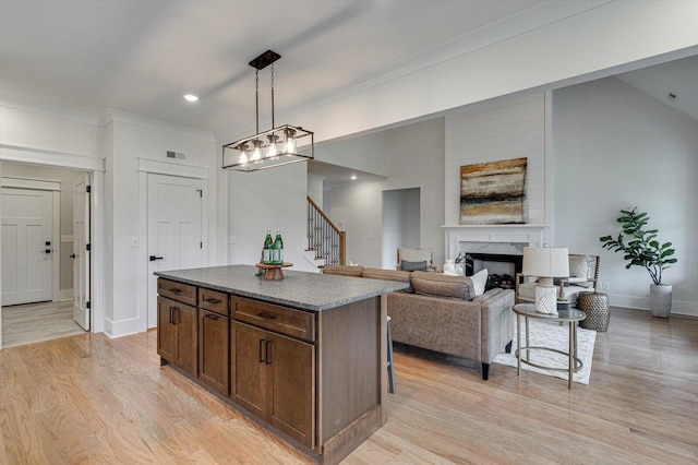 105 Arthur Ln, Cleveland, TN 37312 - kitchen featuring a center island, a high end fireplace, light wood finished floors, hanging light fixtures, and crown molding