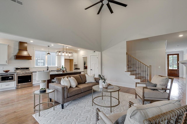 105 Arthur Ln, Cleveland, TN 37312 - living area with healthy amount of natural light, a ceiling fan, stairway, light wood-style floors, and a towering ceiling