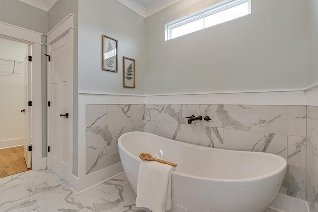 105 Arthur Ln, Cleveland, TN 37312 - full bathroom featuring tile walls, marble look tiles, a soaking tub, wainscoting, and a spacious closet
