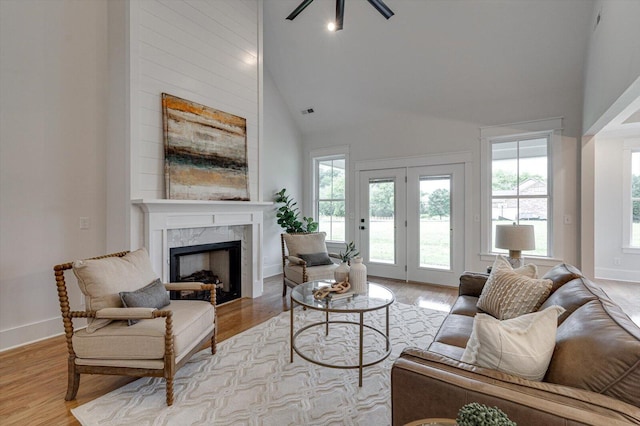 105 Arthur Ln, Cleveland, TN 37312 - living room featuring a fireplace, light wood-type flooring, a ceiling fan, baseboards, and high vaulted ceiling