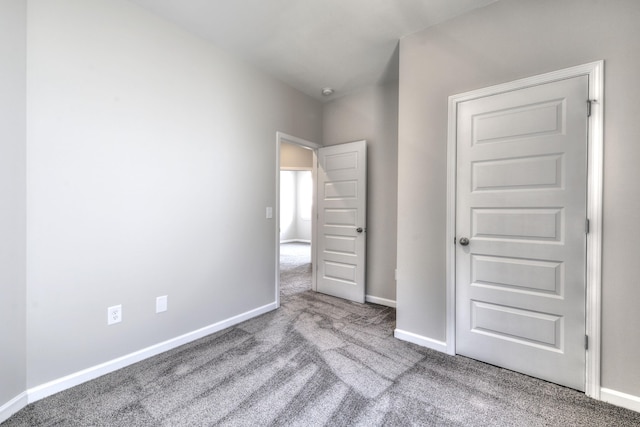 unfurnished bedroom featuring light carpet