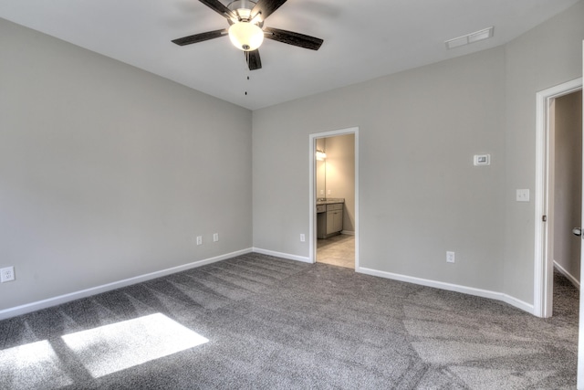 unfurnished bedroom featuring ceiling fan, connected bathroom, and light carpet