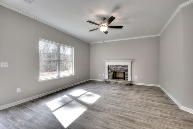 unfurnished living room featuring ceiling fan, a fireplace, crown molding, and wood-type flooring