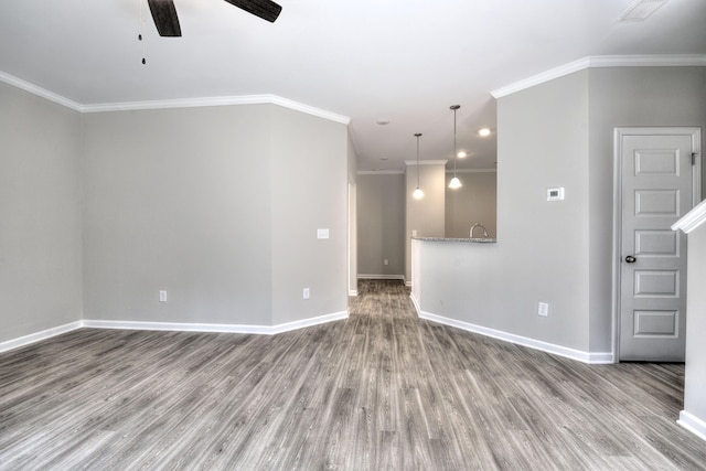 spare room with crown molding, hardwood / wood-style floors, ceiling fan, and sink