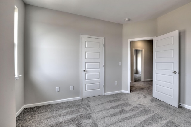 unfurnished bedroom with light colored carpet