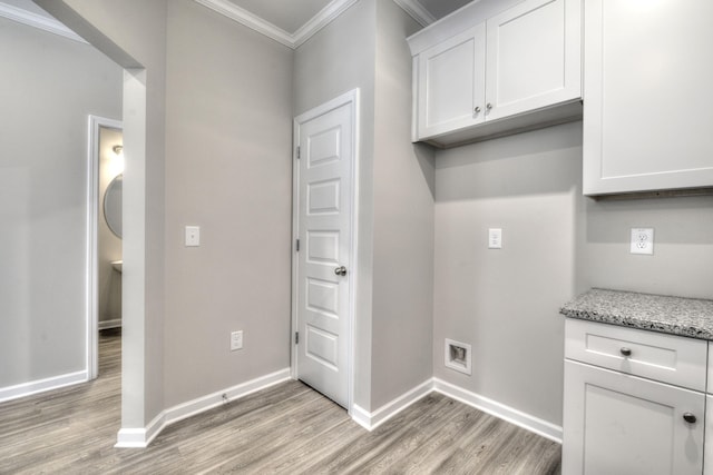 laundry room featuring light hardwood / wood-style flooring and ornamental molding